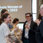 A group of people talk together over refreshments at the event.